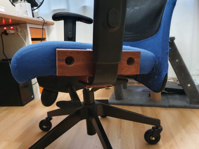 Armrest adaptor bolted to the side of the chair